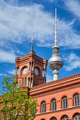 Detail of the tower of the Rotes Rathaus in Berlin with the TV Tower in the back