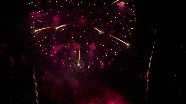 Footage B roll of Real Fireworks on night backgrounds. abstract  real shining fireworks with bokeh lights in the night sky. Celebration fireworks festival and New year's eve. Colorful fireworks.