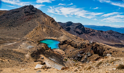 Looking down from the red crater to one of the three Emerald lakes on the Tongariro Alpine crossing in NZ’s Central Plateau