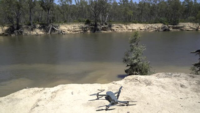 DJI drone turning on and taking off over river