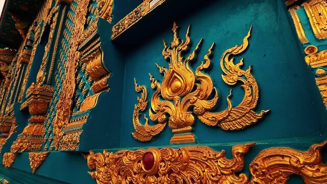 Elaborate bas relief design of the walls of Wat Rong Suea Ten or Blue Temple in Chiang rai Thailand
