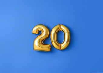 Figure 20 made of balloons on color background