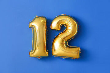 Figure 12 made of balloons on color background