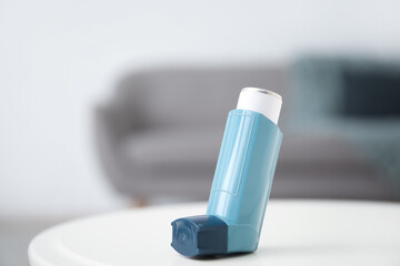 Modern inhaler on table at home, closeup