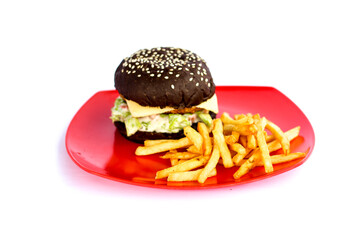 Black burger with french fries isolated on white background on red plate.