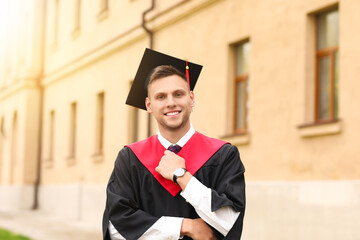 Portrait of male graduating student outdoors