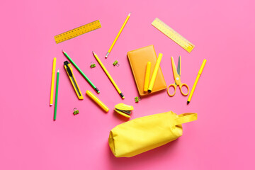 Pencil case with stationery on color background