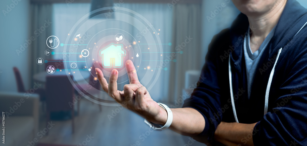 Poster man holding smart home icon as automation assistant on a virtual screen control. panoramic banner of