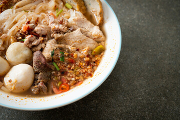 noodles with pork and meatballs in spicy soup