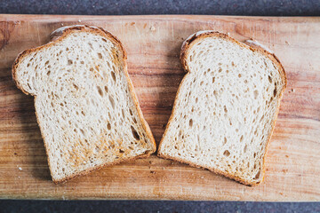 slices of toasted bread on wooden cutting board, natural healthy ingredients