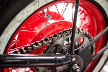 detail of the chain and sprockets of a motorcycle in a mechanic's shop ready for repair