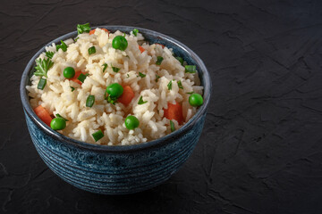 White rice with veggies on a black background