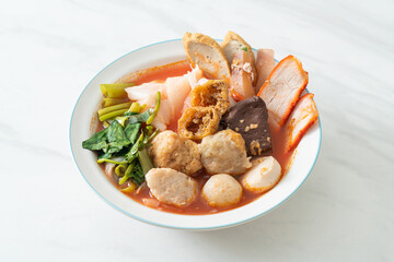 noodles with meatballs in pink soup