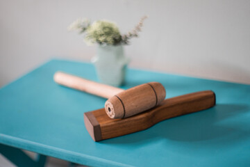 wooden hammer for thai massage with plant