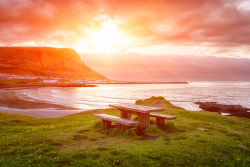 Amazing nature summer landscape, Iceland. Scenic view of the rocky Atlantic coast with wooden table...