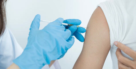 Female doctors vaccinated with syringes to prevent epidemics at hospitals, health care, and medical...