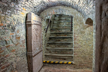 Old dungeons with the stone door and stairs