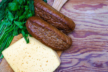 cheese rye bread greens on a cutting board on a wooden surface copy space