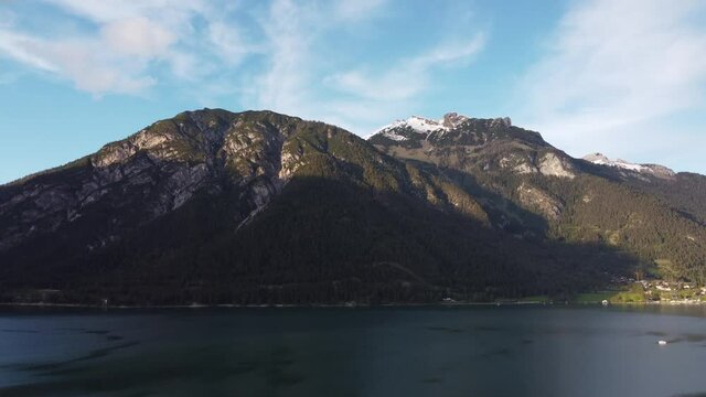 Lake Achensee and mountains aerial timelapse. Water and big mountain peaks. Clouds on the sky. Beautiful view in heart of Alps in Austria.