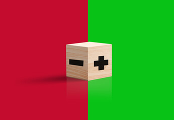 Plus and minus sign in on wooden cube. negative or positive option concept. green and red...