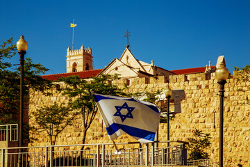 the flag of israel near the walls of the old city of Jerusalem, near the jaffa gate