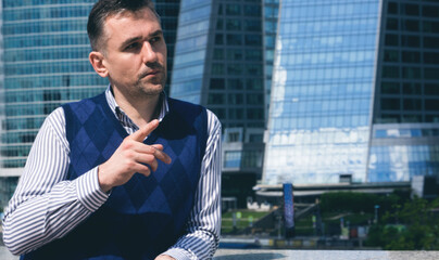 Young man businessman outdoor near office buildings business center