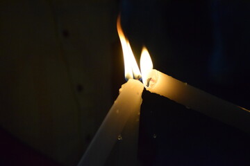 Naklejka premium Three burning candles.