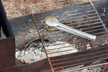 empty barbecue grill and spatula for turning meat extinguished fire