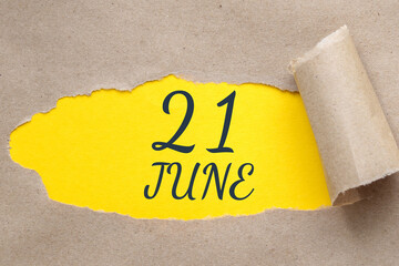 june 21. 21th day of the month, calendar date.Hole in paper with edges torn off. Yellow background...