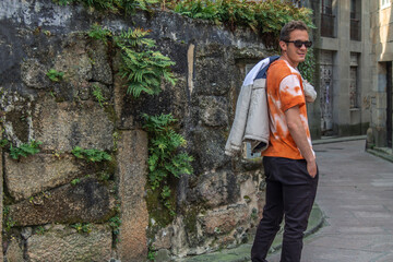 young man tourist walking through the monumental streets