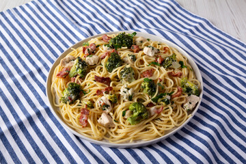 Homemade Chicken Bacon Broccoli Alfredo on a plate, low angle view.