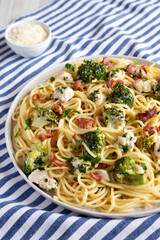 Homemade Chicken Bacon Broccoli Alfredo on a plate, side view.