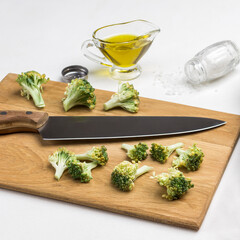 Kitchen knife, fresh cabbage and broccoli on cutting board.
