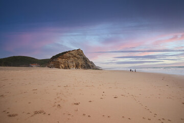 Fototapeta na wymiar Beautiful sandy ocean beach and cliff at the sunset. Panorama atlantic coastline.