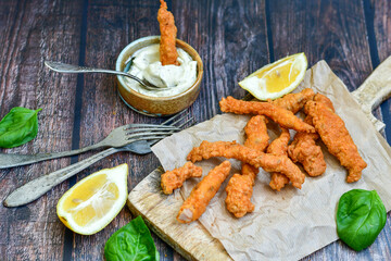 
 Crispy  deep fried home made    chicken strips Breaded  with  almond flour chicken  breast fillets  with chilly peppers and fresh   basil on wooden rustic background. Ketogenic diet food