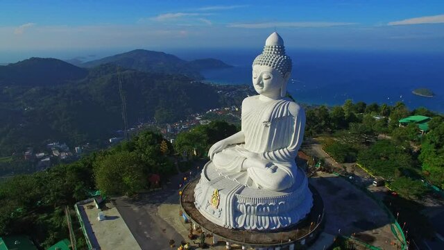 Phuket Big Buddha is one of the island most important and revered landmarks on Phuket island..blue sky and blue sea background.4k video for travel and worship concept.