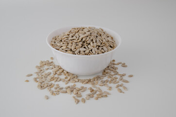 White plate with scattered seeds on a clean background. Proper nutrition.