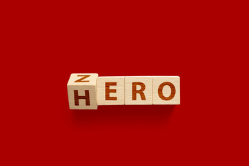 Zero or Hero concept, Wooden cube flip change the word on red background