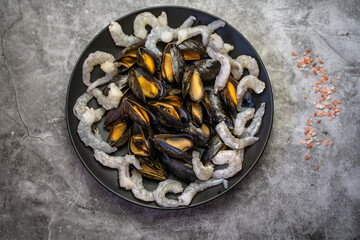 The mussels and the shrimp are ready to be cooked.	