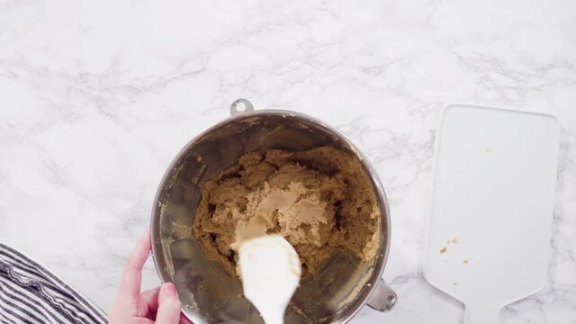 Time lapse. Flat lay. Step by step. Scooping peanut butter cookies dough with dough scooper into the baking sheet.