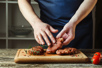 Chef hands cooking meat steak. Chef adding salt and pepper on raw meat. Man cooking meat steak on kitchen.