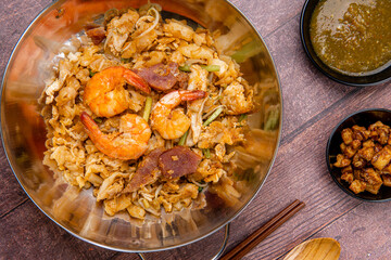 Kwetiau goreng medan or char kway teow It is made from noodles, which are stir fried in cooking oil with garlic, onion or shallots, pork, fried prawn, sliced bakso (meatballs) 