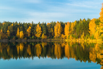 Beautiful forest lake old quarry on a clear autumn day. Forest gave.