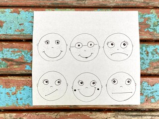 Painted faces with different facial expressions and emotions, kids DIY.
