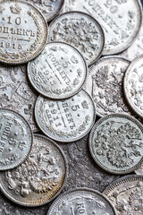 Gold and silver coins of the Russian Empire19 - 20 century in the background kopyur.Five rubles Nicholas II.Concept Russian antiques.Antikvariat.