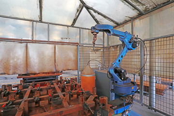 Welding robot in the production workshop in a factory