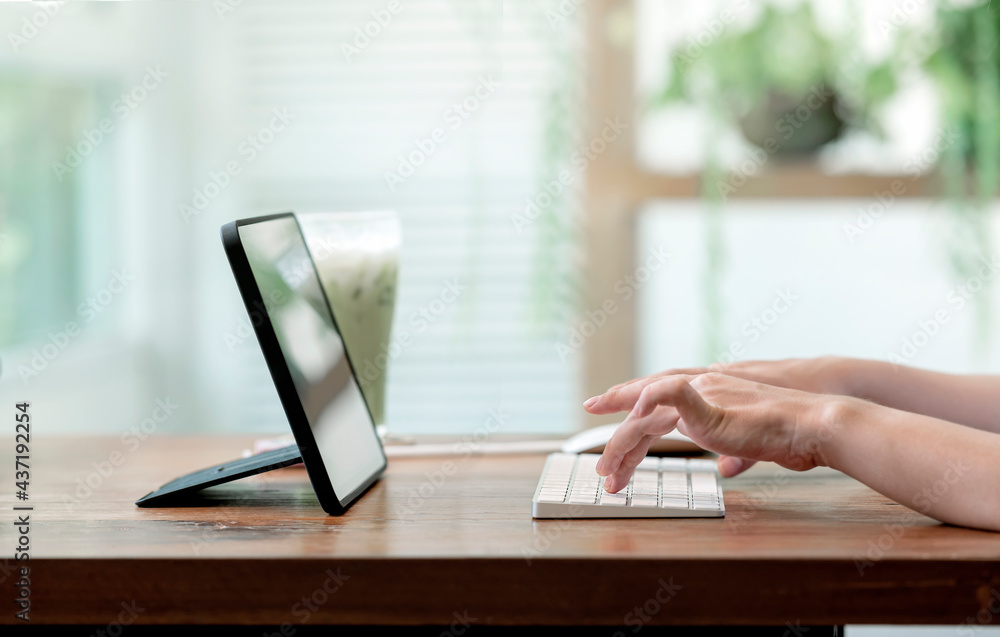 Poster closeup view of woman hands typing on computer keyboard while working from home.
