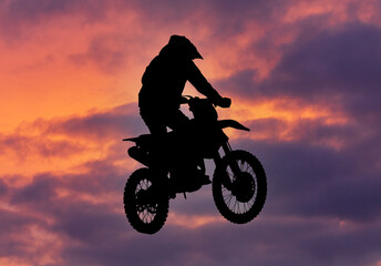 Silhouette of a man on a motorcycle