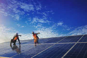 Electrical and instrument technician use wrench to fix and maintenance electric system at solar panel field.