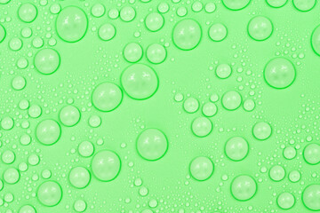 Water drops on green background texture. Backdrop glass covered with drops of water. green bubbles in water.